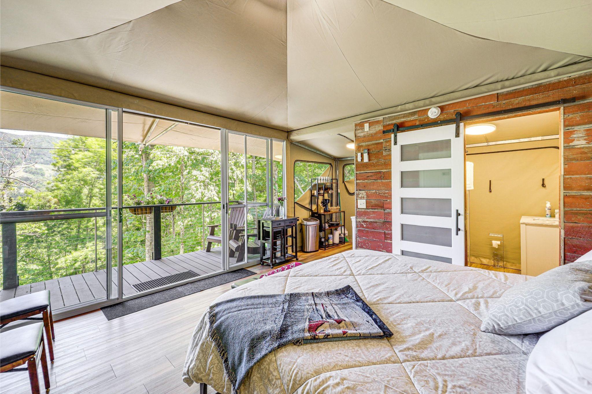Luxury glamping tent at sunset on the ridge with mountain views