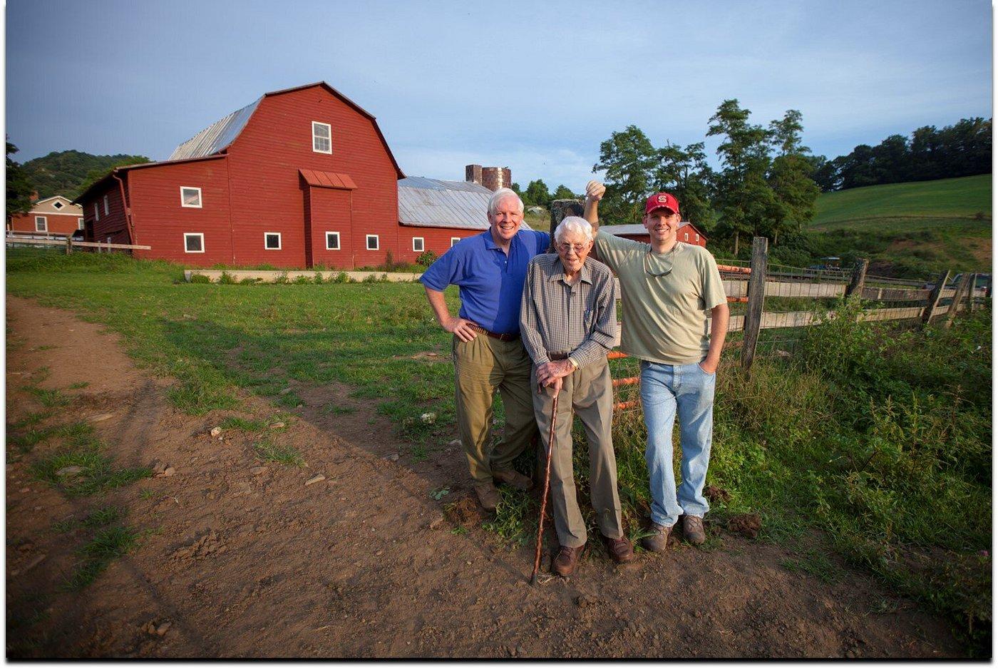 Three generations — Bob, R.G. at 102, and Gray Shipley in front of the red barn